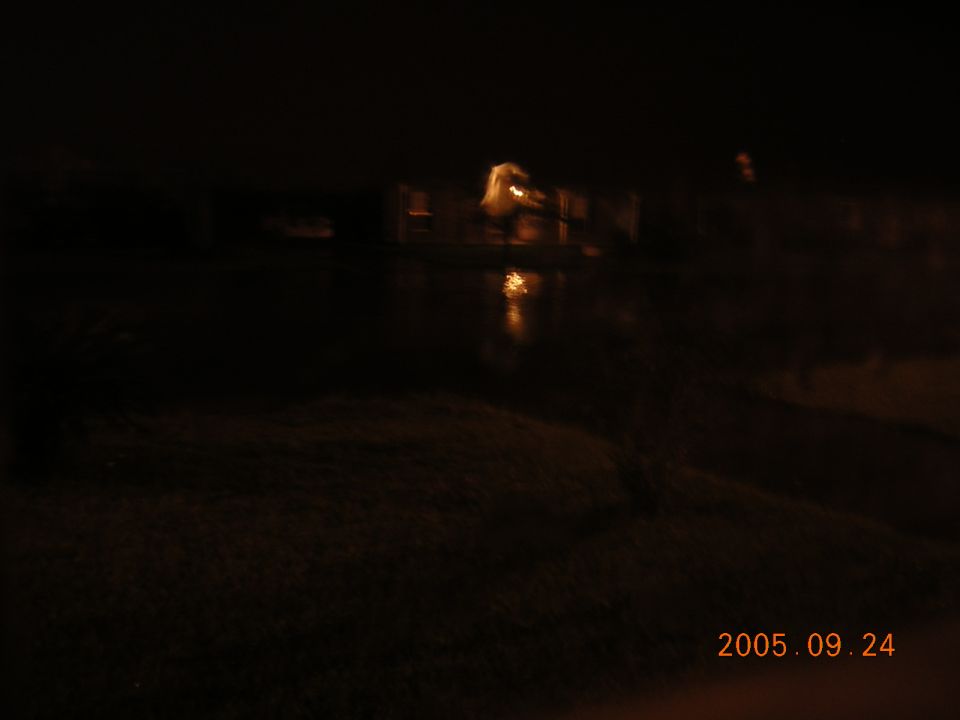 Dark blurry night scene with distant lights and reflections