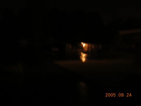 1992 Toyota Hilux - A flooded street is visible at night with lights reflecting on the water's surface.