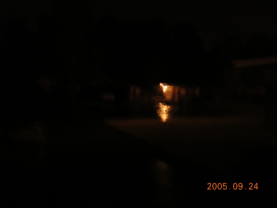 streetlights reflecting on flooded road at night