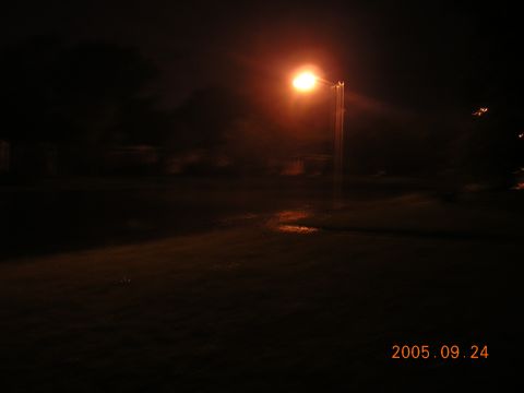 1992 Toyota Hilux - A street lamp casts an orange glow on a dark, wet landscape, with a date and website visible in the lower right corner.