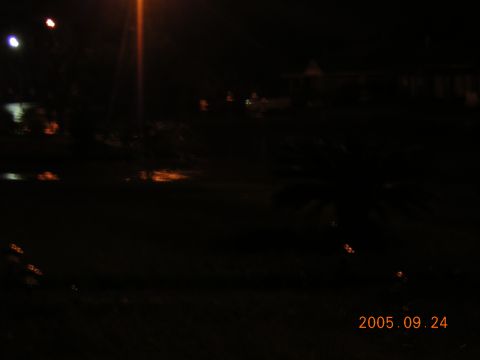 1992 Toyota Hilux - A dark, flooded road scene is captured at night, with reflections visible on the water's surface.