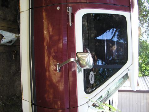 1991 Ford Bronco - Side view of a 1991 Ford Bronco, showing the door, mirror, and a Ford badge on the window.