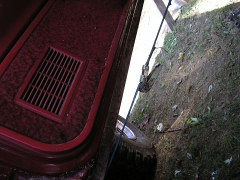 1991 Ford Bronco - The interior of a vehicle shows a rear cargo area with a vent and a tire peeking out from the side.