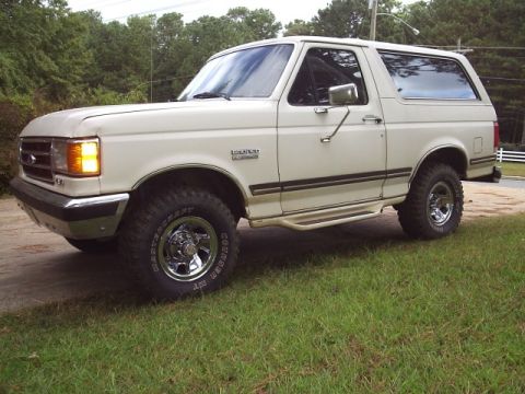 1978 Ford Bronco - This white Ford Bronco features aftermarket chrome wheels and large off-road tires.