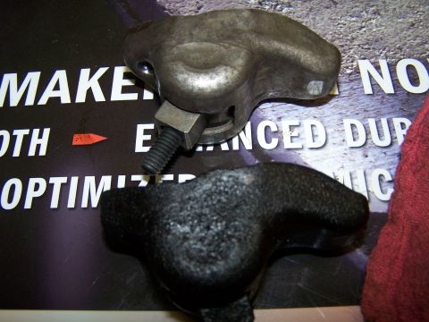 1979 Ford F-150 - A close-up view of two engine rocker arms, one showing significant wear.