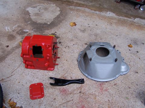 1979 Ford F-150 - Transmission case and bell housing laid out on concrete with clutch fork.