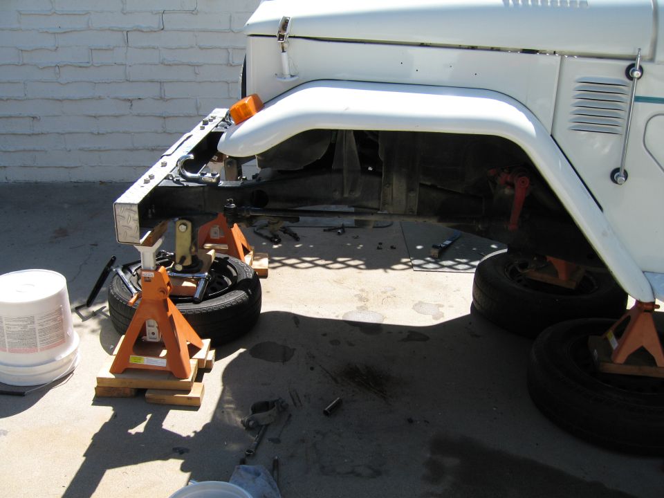 1977 Toyota Land Cruiser front end on jack stands, with wheels removed and suspension components visible