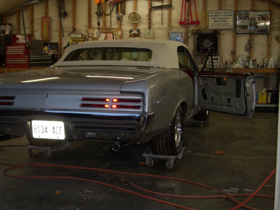 Silver 1967 Pontiac GTO convertible rear view with door open
