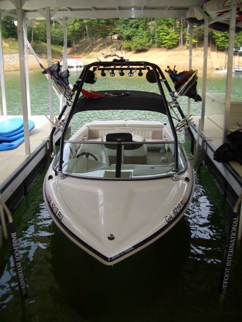 2000 Mastercraft Prostar 190 - A white boat with a wakeboard tower is parked in a covered dock, showing its registration number GA 6219 RU.