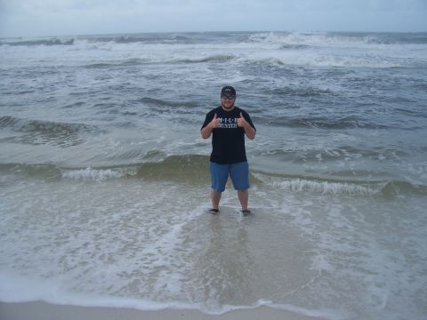 1995 Ford Bronco - A man stands in the ocean, giving a thumbs up with both hands.