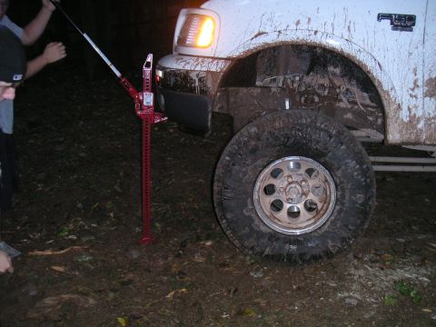 1994 Ford Bronco - Ford F-250 truck stuck in mud, being lifted by a Hi-Lift jack.