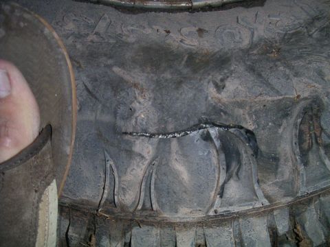 1994 Ford Bronco - The tire tread shows significant damage and wear, indicating a potential issue with the vehicle's tires.