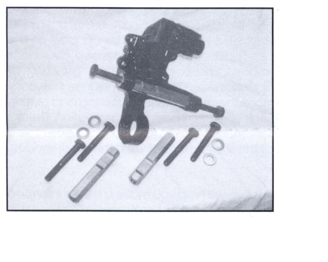 Black suspension part with bolts and washers on a white background