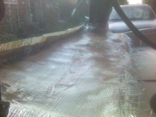 1994 Ford Probe - Fiberglass repair in progress on a car hood, with SuperMotors branding.