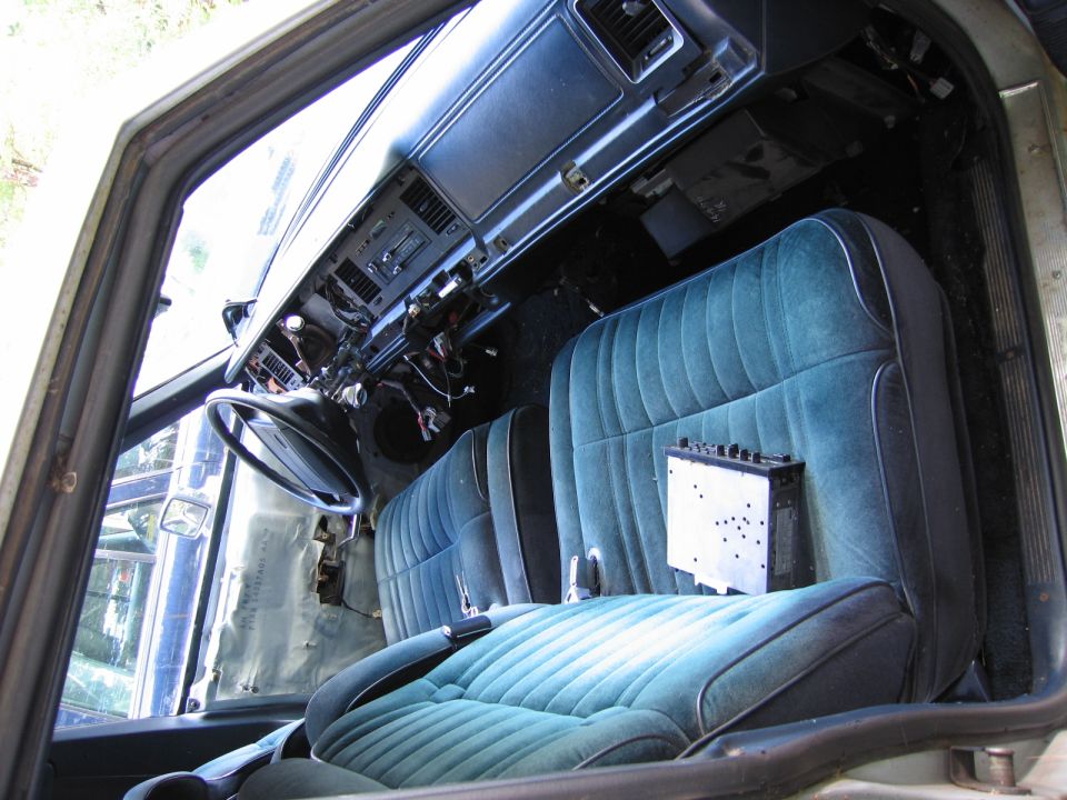 1991 Ford Crown Victoria LTD interior showing removed dashboard and teal velour seats