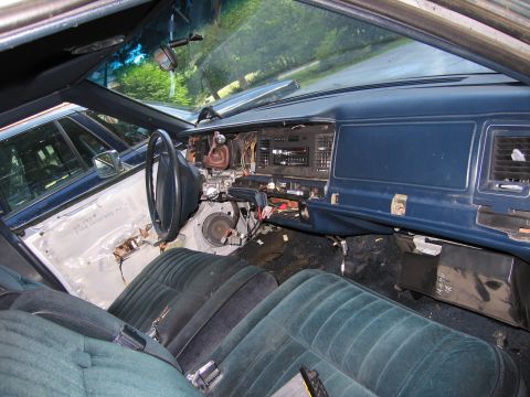 1991 Ford LTD Crown Victoria - The interior of a car is shown with the dashboard disassembled and seats visible.