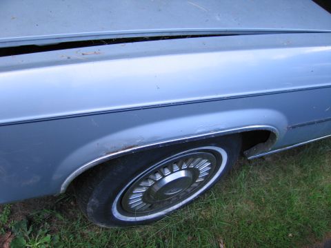 1991 Ford LTD Crown Victoria - Close-up of the side of a 1991 Ford Crown Victoria LTD, highlighting the fender and wheel.