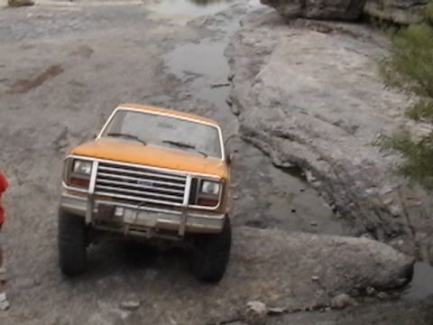 1986 Ford Bronco - Ford Bronco off-roading on a rocky path.