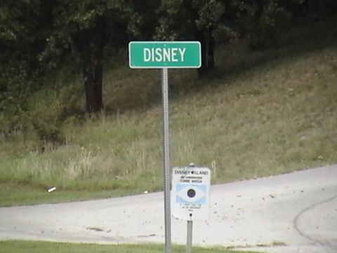 1986 Ford Bronco - Street sign reads DISNEY. Below it is a sign for Disney Island Game Watch.
