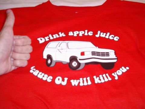 1988 Ford Bronco - A red t-shirt displays a graphic of a white SUV with text that reads 'Drink apple juice 'cause OJ will kill you.'
