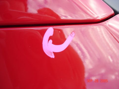 2005 Nissan Titan - A pink inspection mark is visible on the red paint of a vehicle, with a date stamp indicating September 26, 2005.