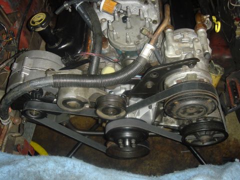 1986 Ford Mustang - Close-up view of engine components including the alternator and AC compressor.