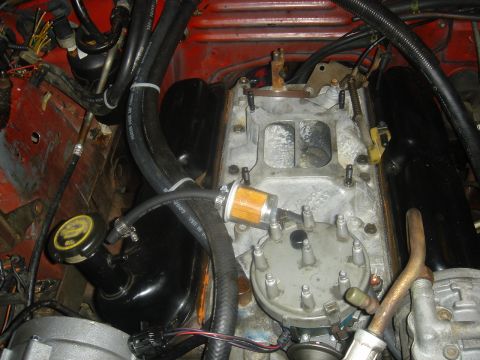 1986 Ford Mustang - Close-up of an engine bay, focusing on the fuel filter and distributor assembly.