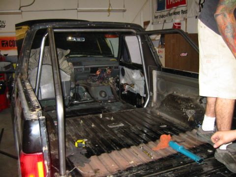 1992 Ford Bronco - Interior view of a pickup truck undergoing modifications, showing a roll cage installation.