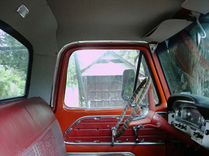 Truck cab interior, orange door panel, headliner, shifter with woven boot wrap