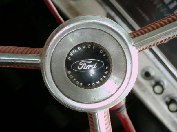 Ford steering wheel center cap, 'Product of Ford Motor Company', red spokes