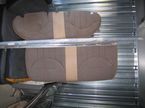 1991 Ford LTD Crown Victoria - Car seat upholstery sections are stored in a metal shelving unit.