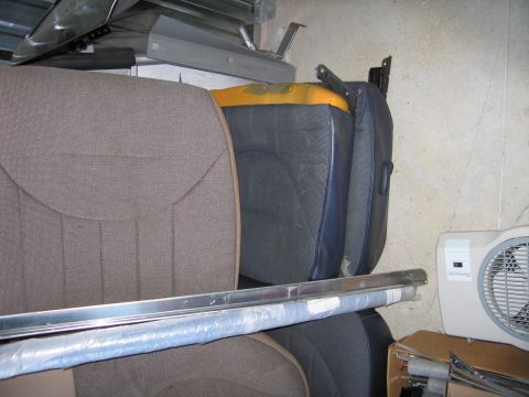 1991 Ford LTD Crown Victoria - Interior car parts, including seats and trim, are stored in a cluttered space.