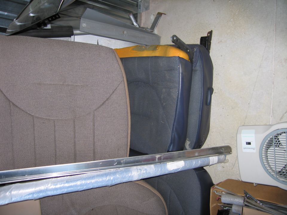 Car seats and trim pieces stacked in storage