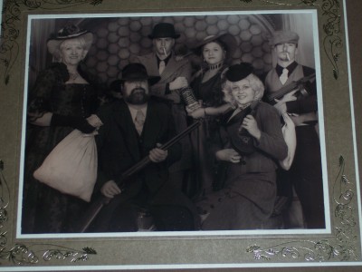 1972 Ford Ranchero - A staged photograph depicts a group of individuals in vintage clothing, posing with replica firearms.