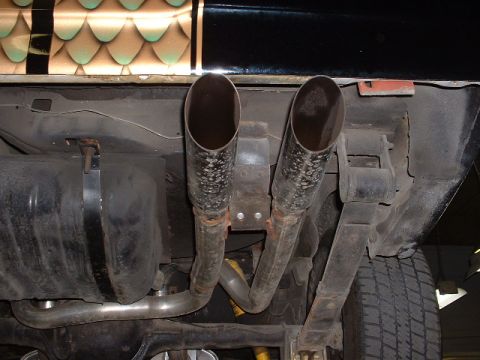 1978 Ford Mustang II - The underside of a vehicle displays its dual exhaust system and fuel tank.