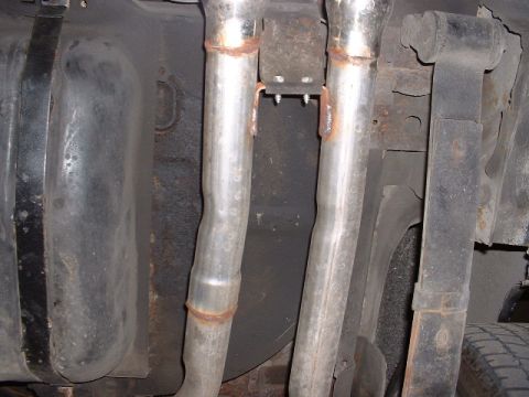 1978 Ford Mustang II - Underside view of dual exhaust pipes and fuel tank, with visible Supermotors.net watermark.