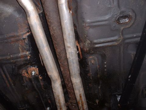 1978 Ford Mustang II - Underbody view shows exhaust pipes and chassis components, likely from an older car.