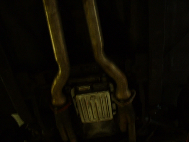 underneath view of dual exhaust pipes and catalytic converter