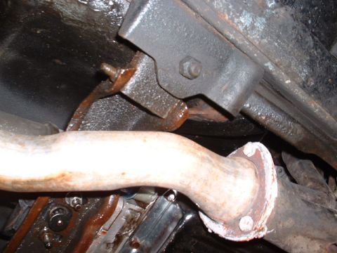 1978 Ford Mustang II - Underside view of a vehicle's exhaust system, focusing on a pipe connection and mounting hardware.