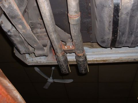 1978 Ford Mustang II - Underside view of a vehicle's exhaust system and fuel tank components.