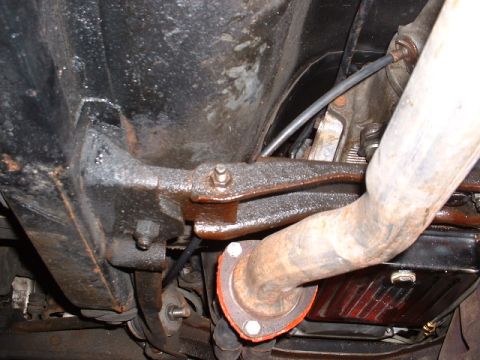 1978 Ford Mustang II - Close-up of the exhaust system and undercarriage of a vehicle, showing rusted parts and mechanical details.