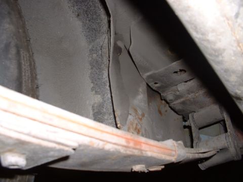 1978 Ford Mustang II - Close-up view of the undercarriage, showing a leaf spring and signs of rust.
