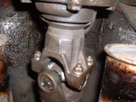 1978 Ford Mustang II - This photo shows a close-up view of a vehicle's driveshaft universal joint, with visible bolts and grease.