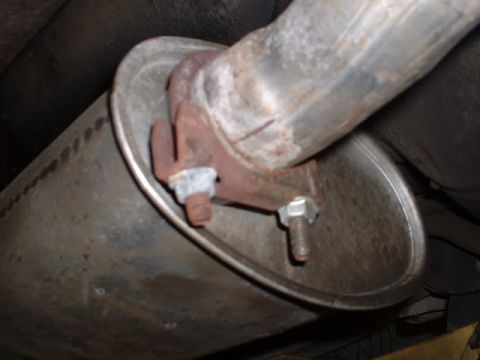 1978 Ford Mustang II - Close-up view of a vehicle's exhaust system, showing the muffler and pipe connection.
