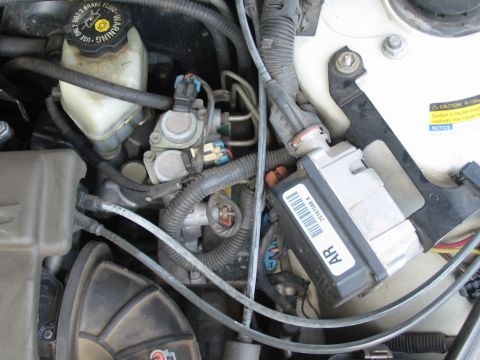 1997 Pontiac Grand Prix - Close-up view of a vehicle's engine bay, showing various components and wiring.
