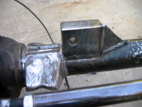 1985 Ford Bronco - A custom metal bracket is welded onto a vehicle's axle housing, indicating modification work.