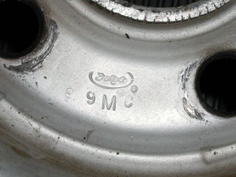 1967 Ford Ranchero - A close-up view of a Ford wheel rim shows stamped markings including the Ford logo and '9 M C'.
