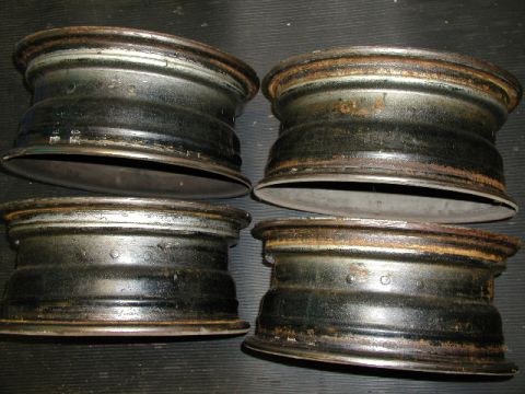 1967 Ford Ranchero - A set of four used steel wheels are shown, exhibiting signs of age and rust.
