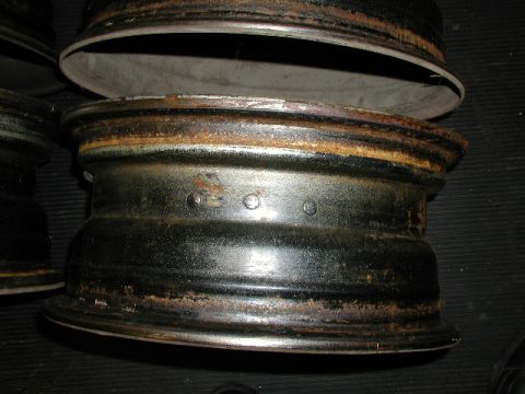 1967 Ford Ranchero - Close-up of a rusty steel rim, suggesting it is a used part for a vehicle.