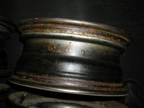 1967 Ford Ranchero - A single rusty rim with black paint is shown, likely from a vintage vehicle.